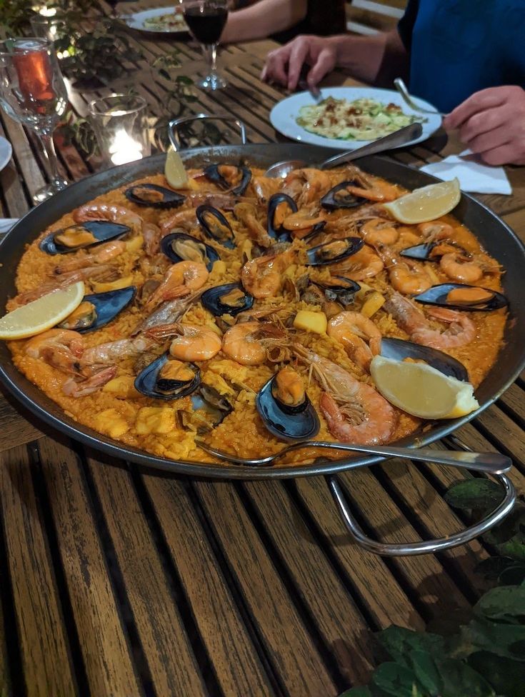 a large platter of seafood and rice on a table