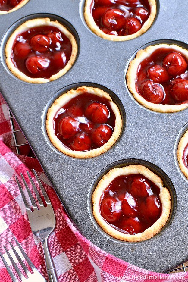 a muffin tin filled with mini cherry pies