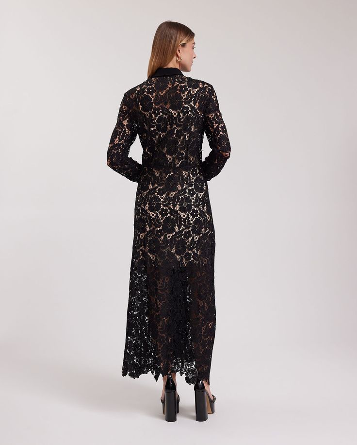 The VIOLETA is a semi-sheer black floral lace dress with a pointed collar and a white button placket that extends down the center front. This full-length dress features a removable sheer dress lining and long sleeves that are finished with single cuffs that allow for cufflinks. The VIOLETA is adorned with a delicate floral scalloped hem and princess darts on the back for a more accentuated silhouette. The VIOLETA dress is being revisited for the Spring-Summer 2023 collection as a complimentary s Formal Sheer Lace Maxi Dress, Elegant Sheer Maxi Length Lace Dress, Elegant Sheer Lace Maxi Dress, Long Sheer Lace Dress, Evening Dress With Sheer Sleeves, Chic Floor-length Lace Dress For Formal Occasions, Chic Formal Floor-length Lace Dress, Evening Long Lace Maxi Dress, Evening Lace Long Maxi Dress