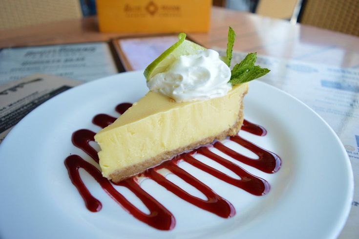 a slice of cheesecake with whipped cream and garnish