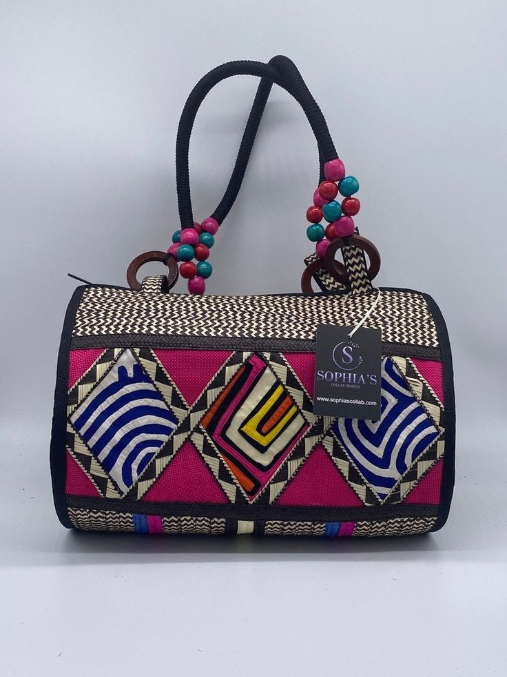 These beautiful handbags are made from Cana Flecha which is an indigenous palm fiber found in the northern territory of Colombia. They are beautifully hand crafted by the people from the Zenu tribes in Colombia. These handbags are colorful with vibrant colors, which is a pure reflection on the region and the warmness of these master artisans that work in this industry every day. Traditional Satchel Beach Bag, Traditional Satchel Bag For Beach, Traditional Rectangular Vacation Bag, Traditional Rectangular Vacation Bags, Traditional Top Handle Bag In Natural Color, Traditional Top Handle Shoulder Bag In Natural Color, Multicolor Rectangular Jute Bags, Traditional Natural Top Handle Shoulder Bag, Traditional Natural Color Top Handle Shoulder Bag