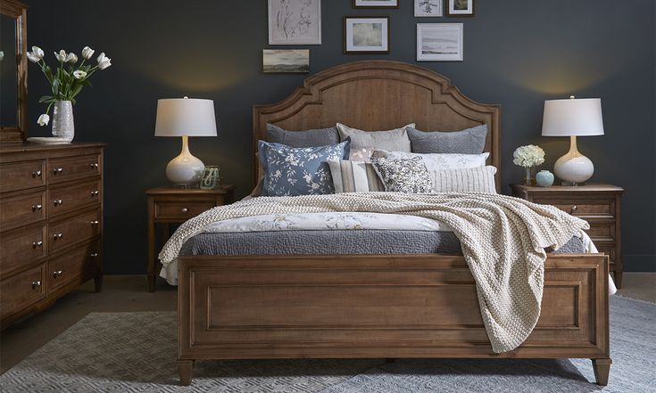 a large bed sitting next to two lamps on either side of it in a bedroom