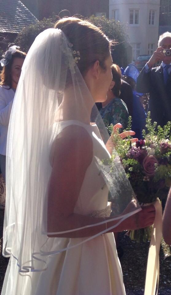 a woman in a wedding dress holding a bouquet