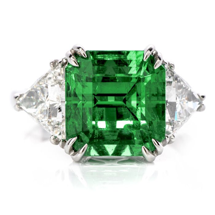 This Stunning Square Colombian Emerald Diamonds handcrafted is solid platinum.Displaying vibrancy and elegance, it is centered with 1 genuine square cut Emerald extremely fine in color and clarity,weighing approx. 5.81carats, measuring 10.78mm X 10.23mm X 8.53mm,GIA certified set in claw prongs.This rare Colombian emerald Flanked in between 2 genuine triangular cut Diamonds approx. 1.90 carats, F-G color, VS1 clarity, Set in prong.This classic Ring is in New condition.Weighs: 8.3 GramsMeasures: Luxury Gia Certified Platinum Gemstones, Classic Platinum Gemstones Gia Certified, Gia Certified Platinum Classic Gemstones, Classic Gia Certified Platinum Gemstones, Gia Certified Platinum Gemstones Fine Jewelry, Luxury Brilliant Cut Platinum Gemstones, Luxury Gia Certified White Gold Gemstones, Luxury White Gold Gia Certified Gemstones, Luxury Green Diamond Ring In Platinum