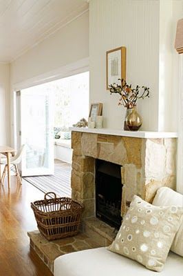 a living room filled with furniture and a fire place in front of a tv screen