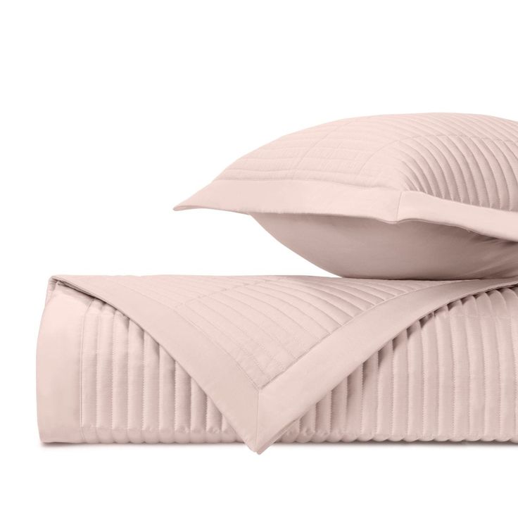 two pillows on top of each other with pleated edges