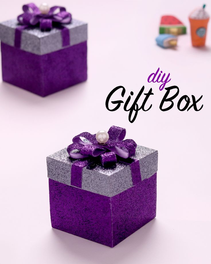 two purple and silver gift boxes with bows