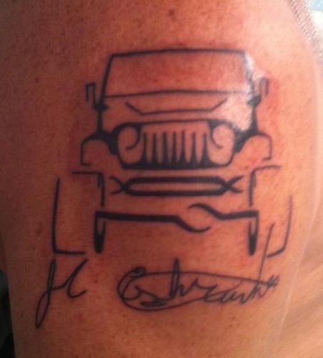 a man with a tattoo on his arm that has a car and the words, it's cheetah