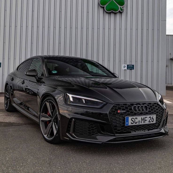 a black car parked in front of a building