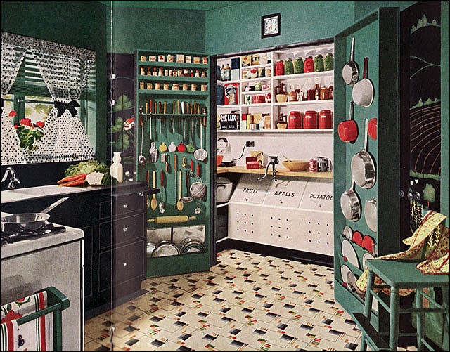 an old fashioned kitchen with green walls and cabinets