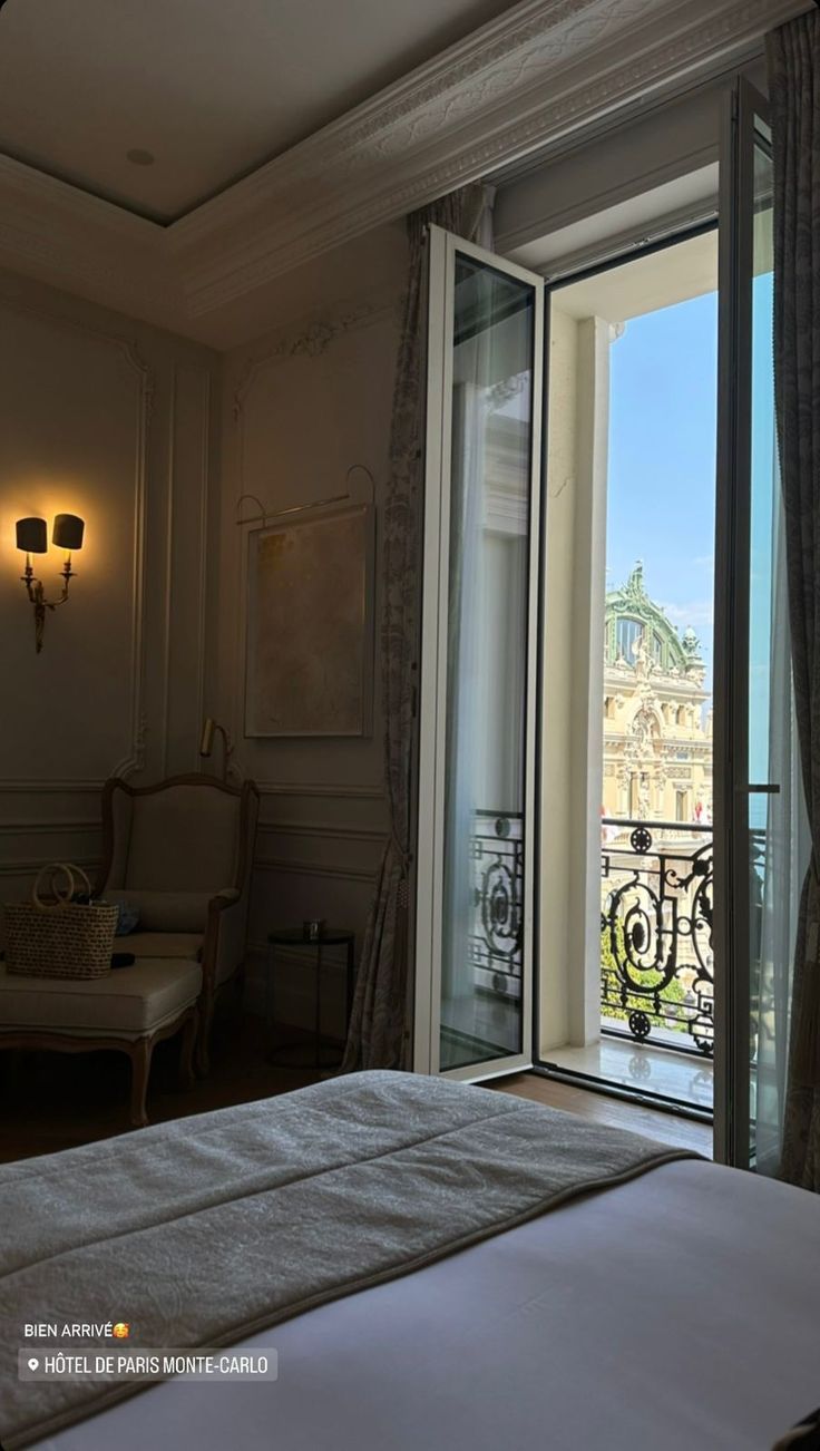 a bedroom with a balcony overlooking the city