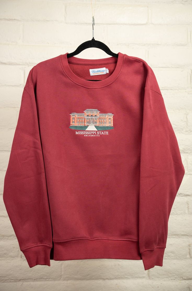 a red sweatshirt hanging on a brick wall