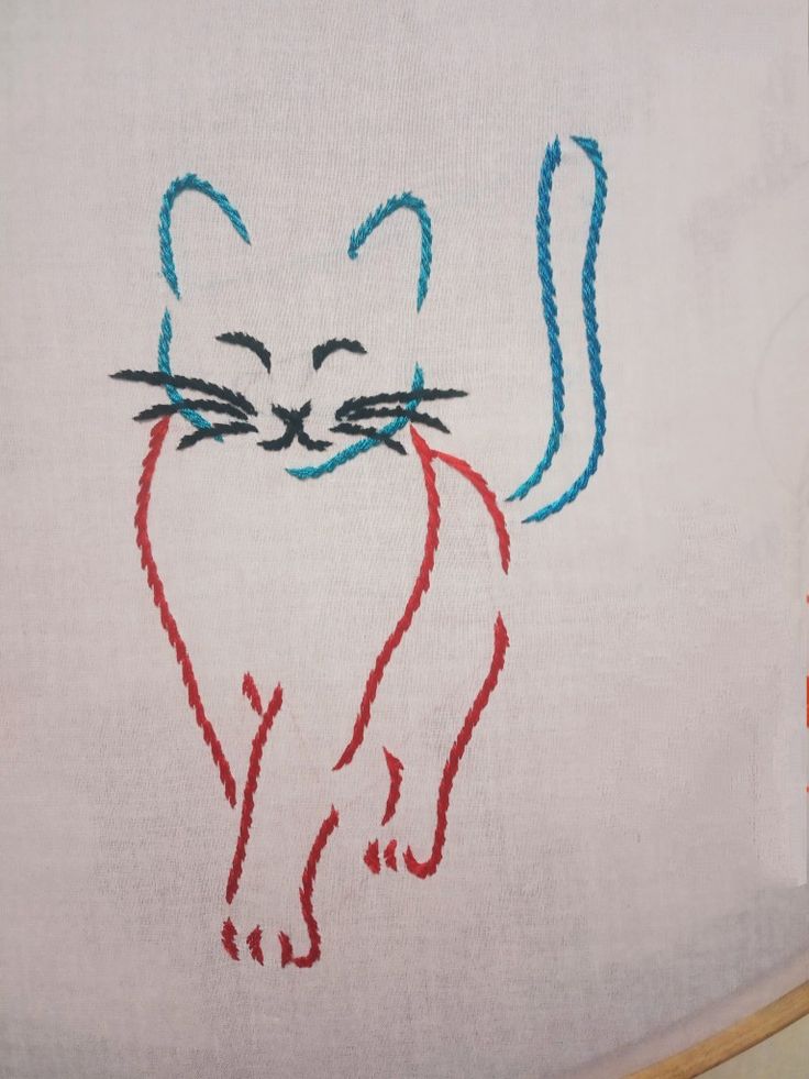 a white towel with a red and blue cat drawn on it's front end