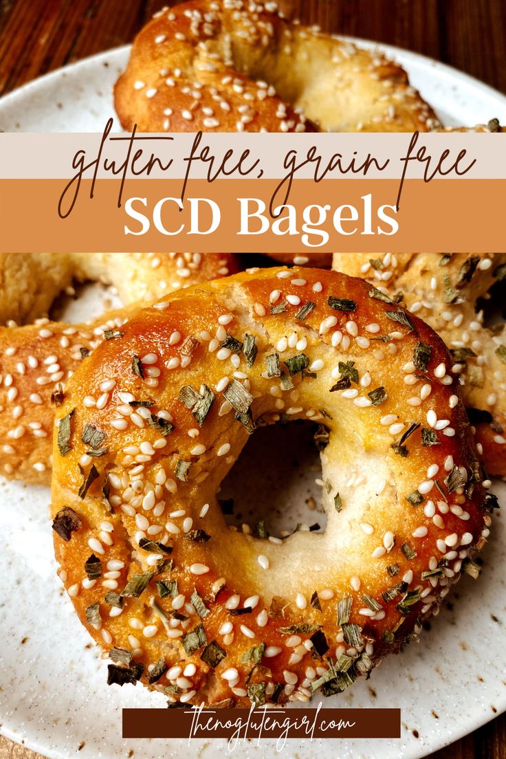 bagels on a plate with sesame seeds and seasoning sprinkled around them