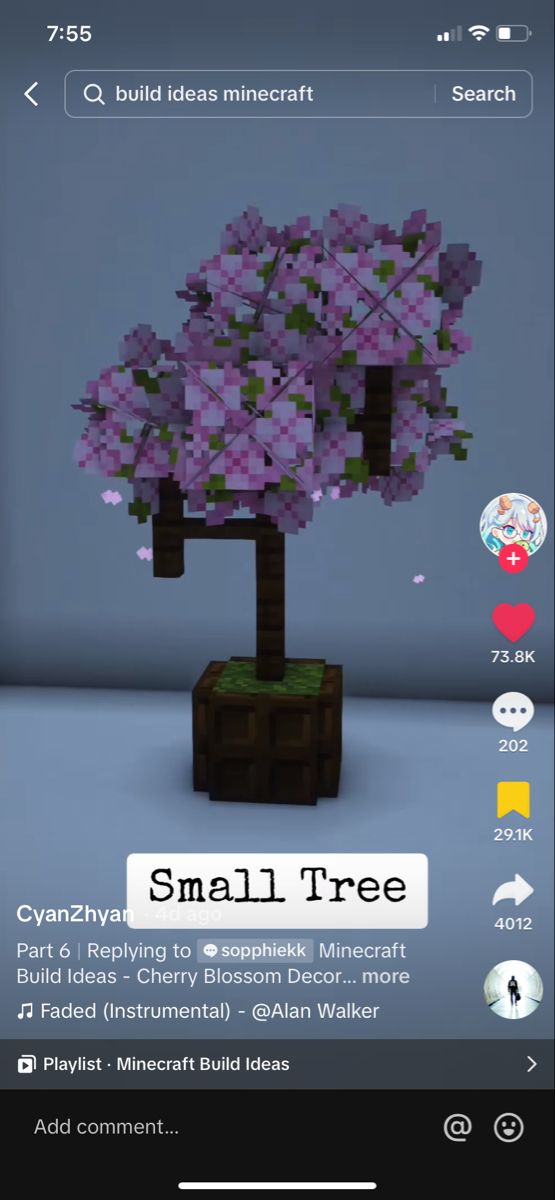 the small tree is made out of legos and has purple flowers on it's branches