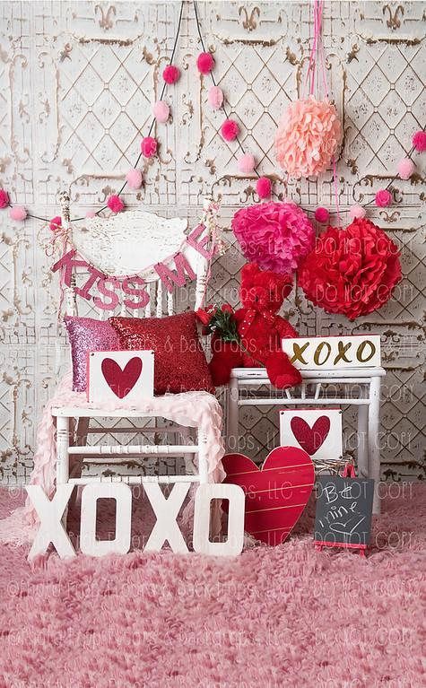 valentine's day decorations are displayed in front of a wall with hearts and flowers