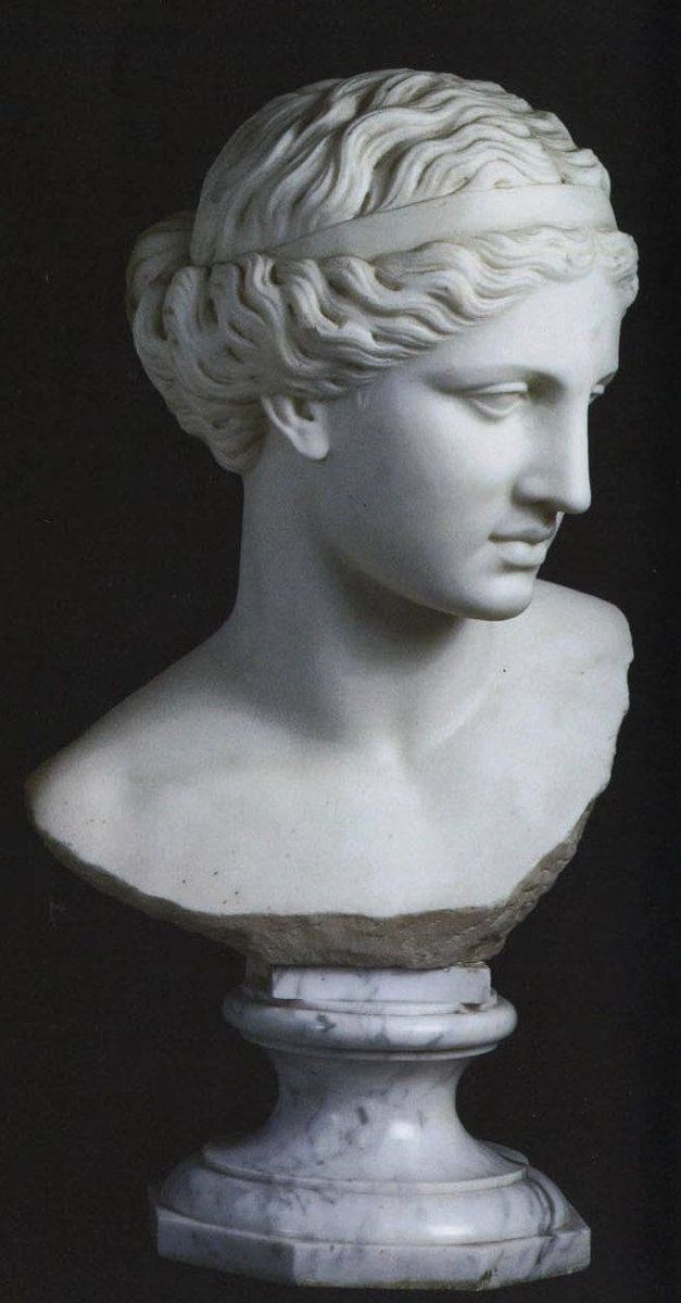 a white marble bust of a woman with braids