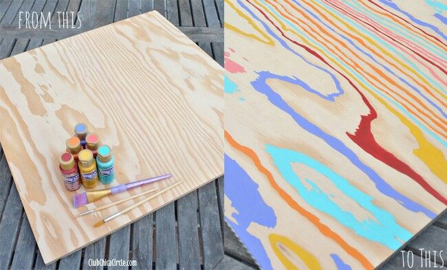 some paint sitting on top of a piece of wood next to other paints and brushes