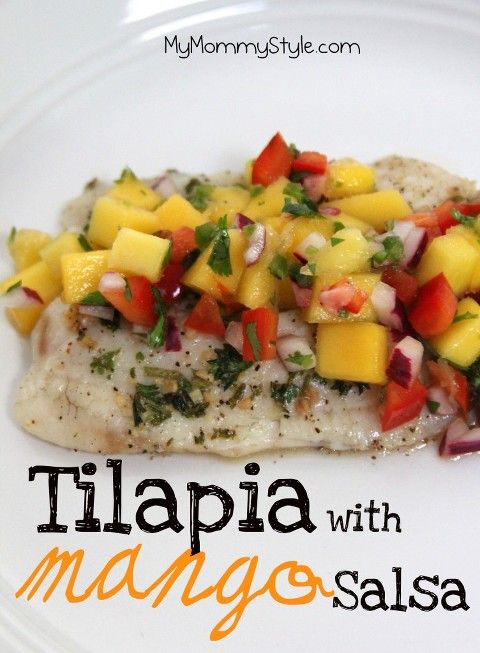 a white plate topped with fish covered in mango salsa