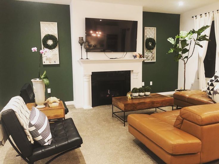 a living room filled with furniture and a flat screen tv mounted on the wall above a fireplace