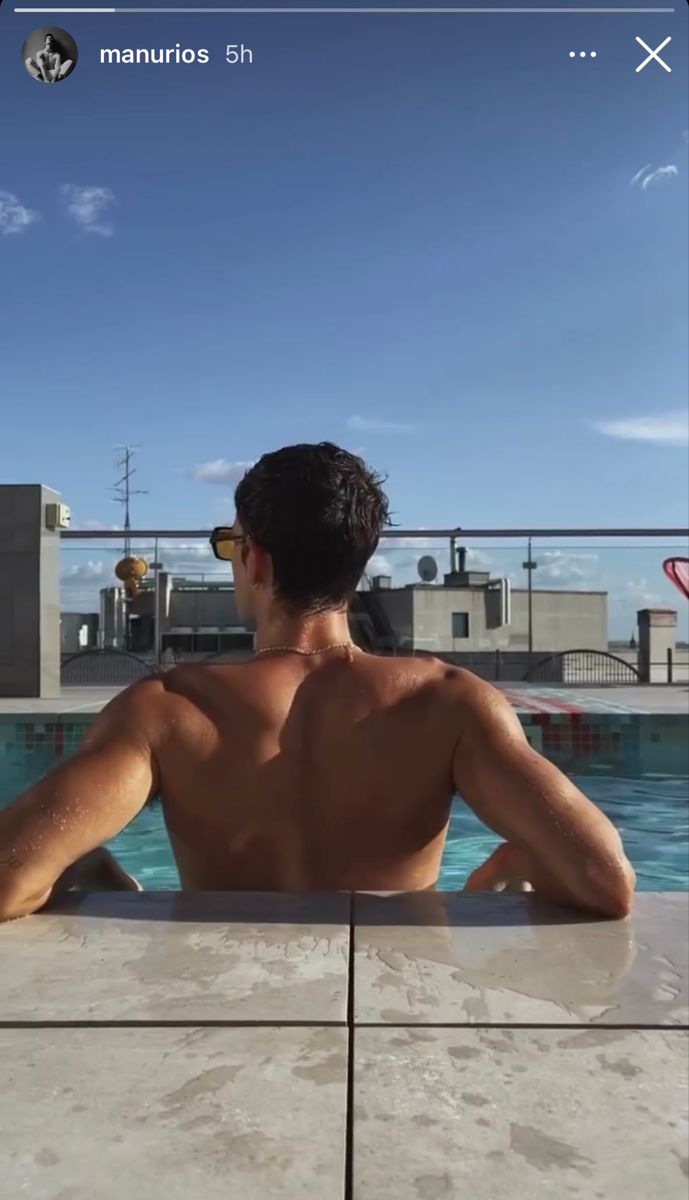 a man sitting in a hot tub looking out at the ocean