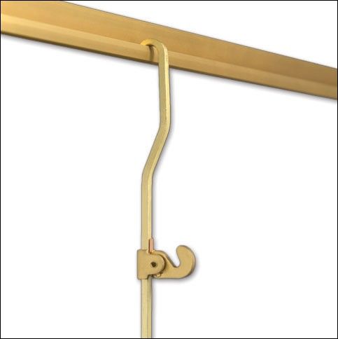 a gold coat rack with two hooks on it's sides and a white background