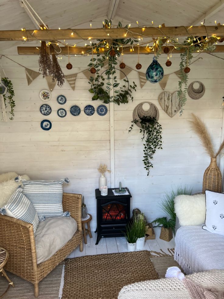 a living room with wicker furniture and plants hanging from the ceiling, along with potted plants