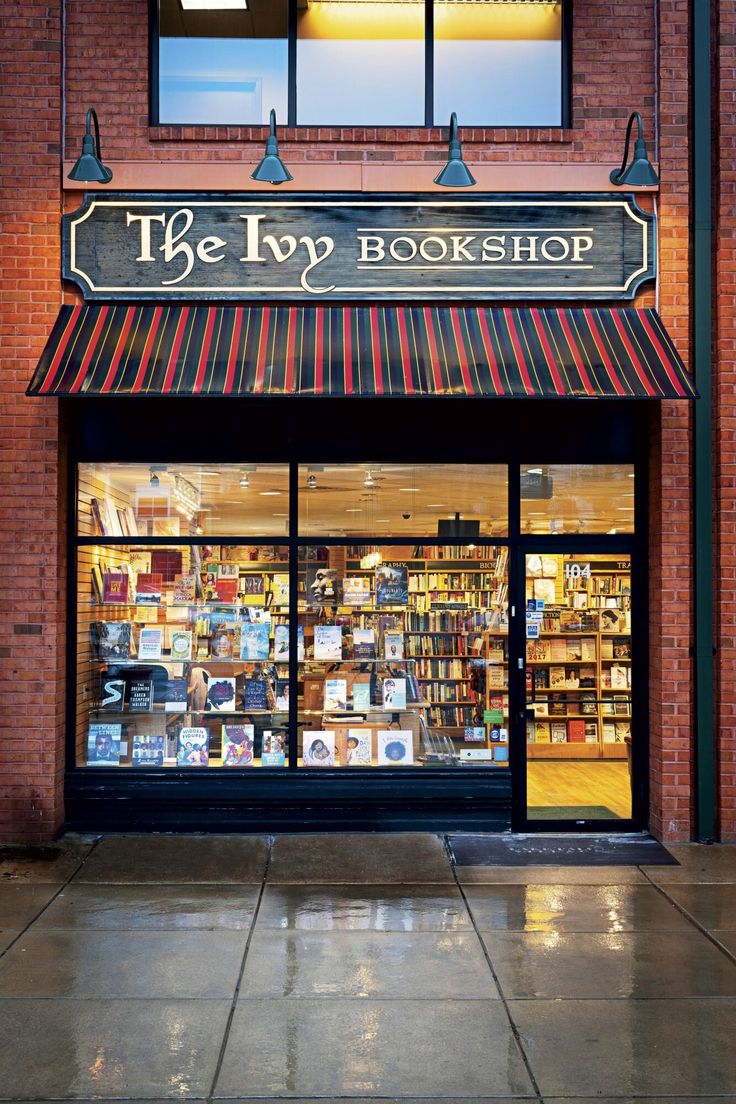 the book shop has many books in it's windows and there are no people outside