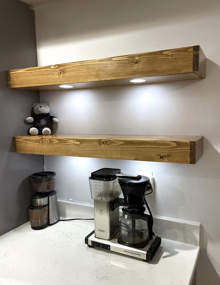 two wooden shelves above a coffee maker on a counter