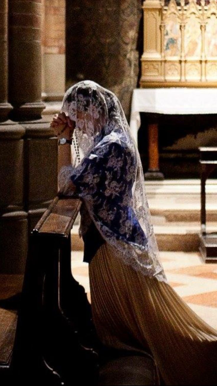 a woman sitting on top of a wooden bench next to a piano in a church