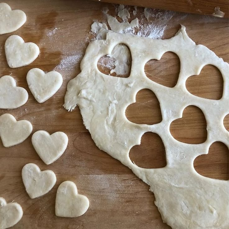 heart shaped dough being made on a cutting board