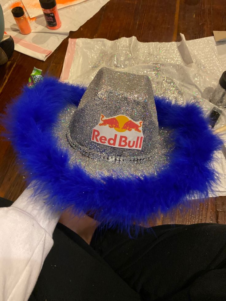 a red bull hat sitting on top of a wooden table