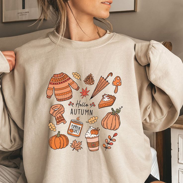 Introducing our delightful super soft and comfy  sweatshirt, adorned with a captivating collage of fall-essentials, and proudly declaring, "Hello Autumn" Embrace the cozy vibes of autumn as you slip into this soft and comfy sweatshirt that's perfect for the crisp weather.Whether you're strolling through the golden-hued parks or enjoying curling up in a chair with your favorite current book, this sweatshirt will be your perfect companion throughout the fall season. Embrace the magic of fall with Cute Fall Shirt, Halloween Retro, Vintage Thanksgiving, Pumpkin Sweatshirts, Halloween Vintage, Fall Gifts, Pumpkin Shirt, Hello Fall, Fall Shirt