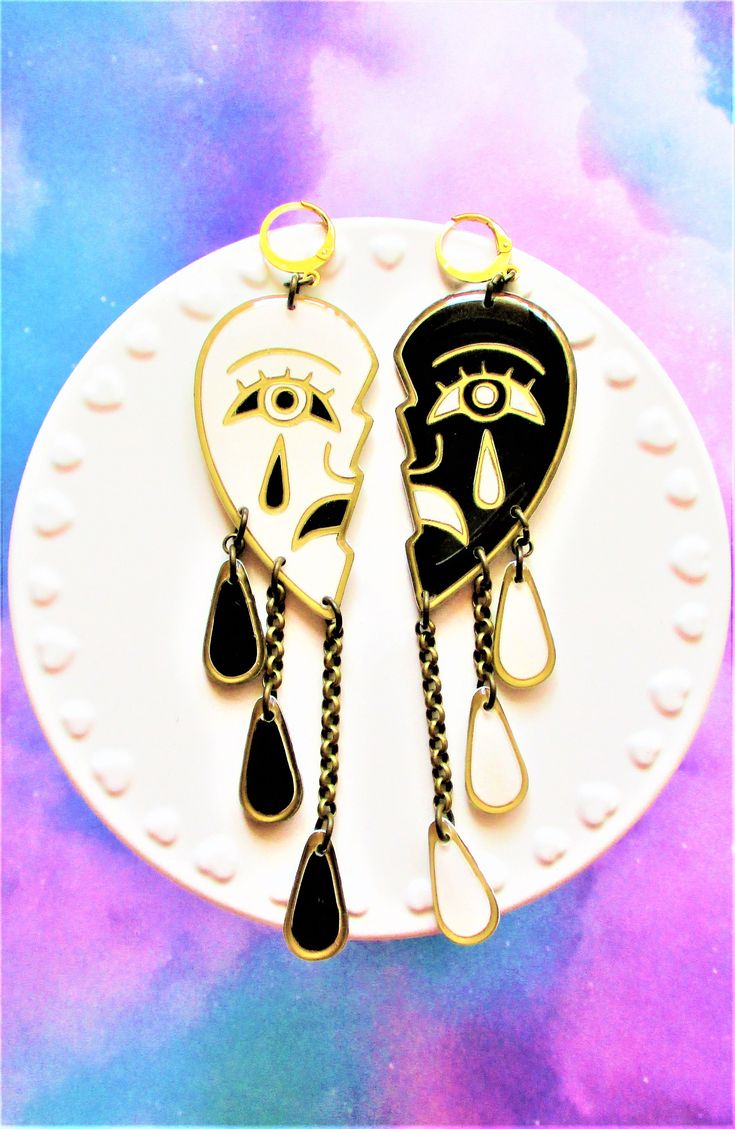 Black and White Sad Crying Face Drama Earrings. Handpainted Resin Earrings. These earrings make a statement! One side is white and one side is black with tear drops dangling from them. Stainless steel huggie hoops. Stainless steel chain. About 5 inches long in total. Super lightweight as always. Comes gift wrapped. Artistic Black Dangle Jewelry, Artistic Black Dangle Earrings, Megan Moore, Crying Face, Multiple Earrings, Tear Drops, Cardboard Jewelry Boxes, Dog Earrings, Face Earrings