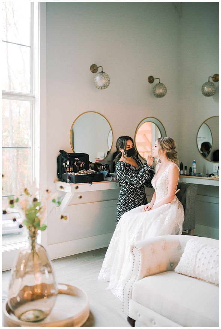 the bride is getting ready for her big day in the room with friends and family