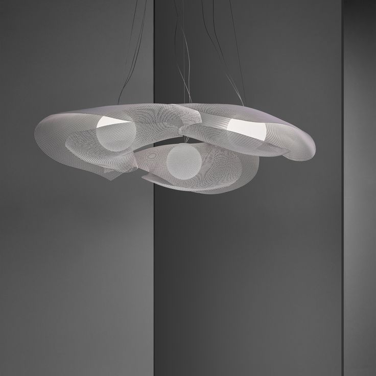 three circular lights hanging from the ceiling in a room with grey walls and flooring