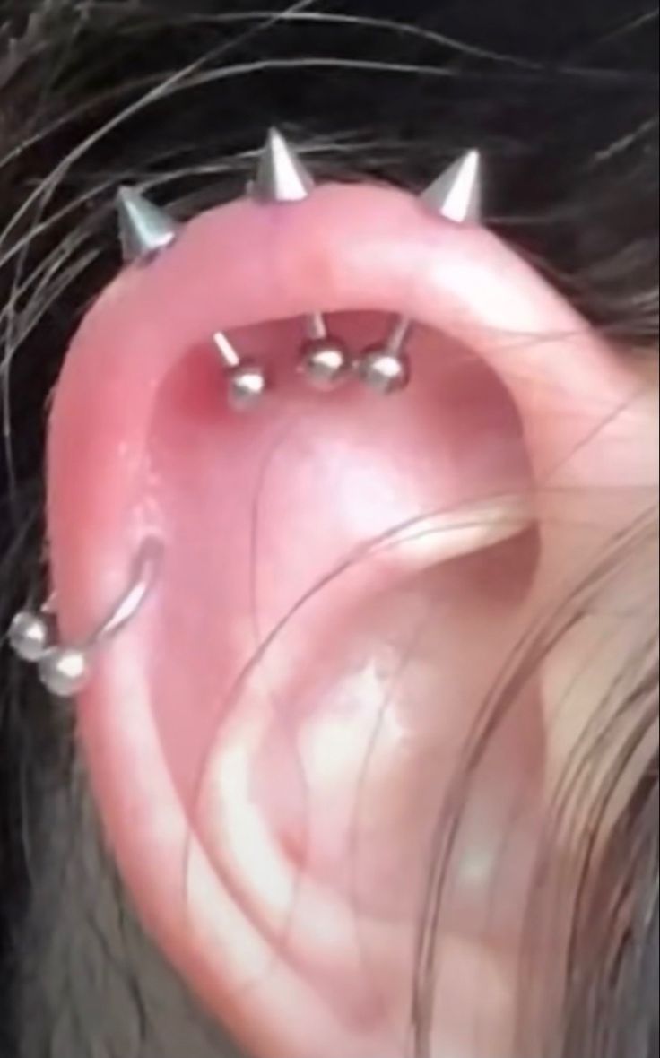 a person with some piercings on their ear