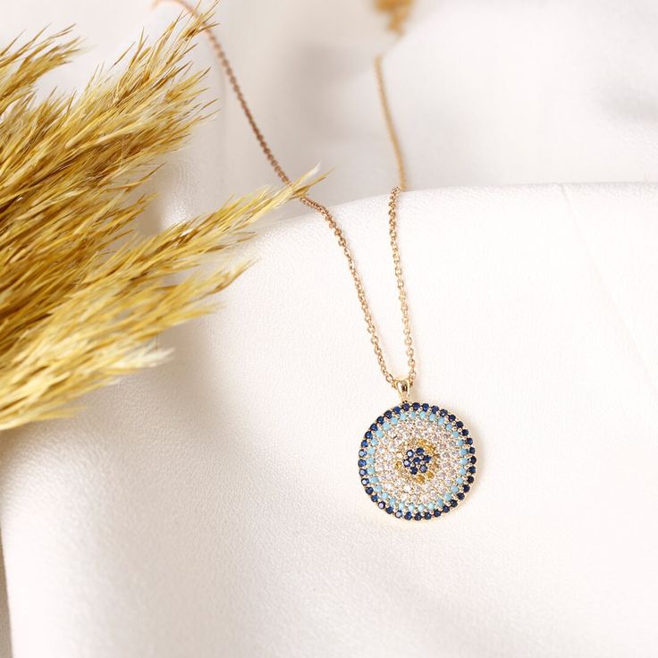 GOLD EVIL EYE NECKLACE - 14K Gold Plated Brass - AAA Best Quality Cubic Zirconia Stones - Dainty and non-Faded Chain ( Chain length: 20 inches; 16" + 4" extender ) - Our necklace has a round shape. Diameter is 0.75". A Quarter Coin has 0.95" diameter. Discover the perfect summer accessory with our Lucky Kabbalah waterproof jewelry collection, featuring exquisite designs inspired by the protective power of the Nazar Blue and White Evil Eye.  Whether you're seeking a thoughtful gift for Mom or a c Yellow Gold Round Necklace As Gift For Her, Yellow Gold Round Necklace For Her, Gold Evil Eye Necklace In Fine Jewelry Style, 14k Gold Amulet Necklace For Gift, 14k Gold Amulet Necklace As Gift, 14k Gold Amulet Necklace Gift, Yellow Gold Evil Eye Jewelry For Anniversary, 14k Gold Evil Eye Necklace, Evil Eye Medallion Necklace As Gift