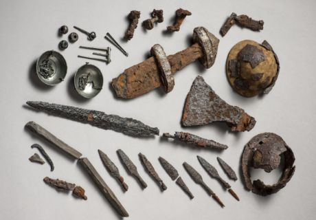 an assortment of old tools are displayed on a white surface