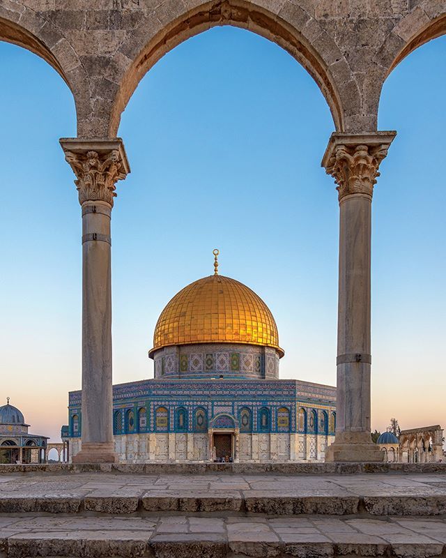 the dome of the rock in the middle of an open area with pillars and arches