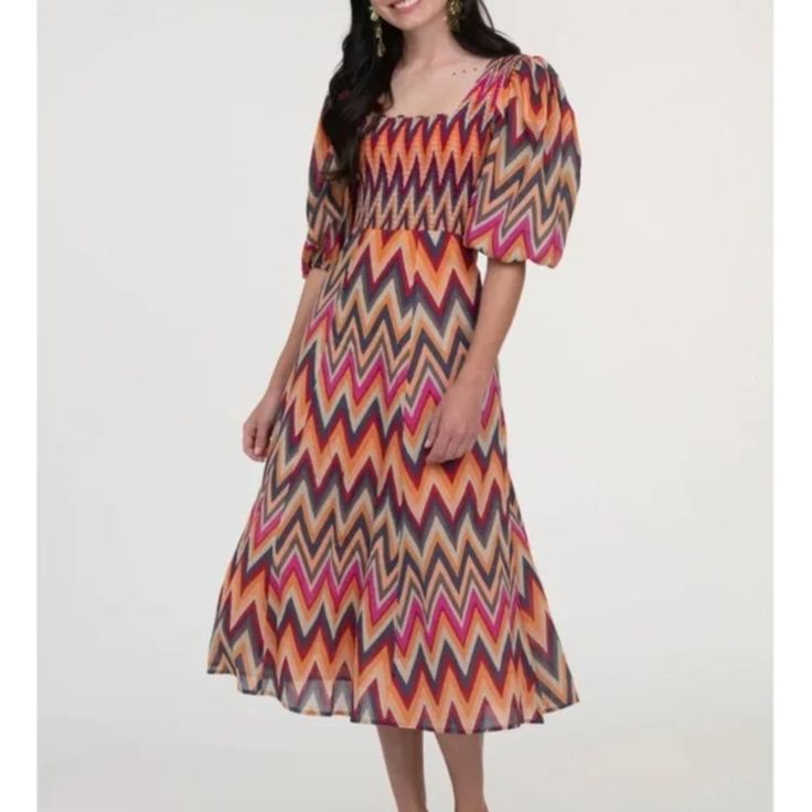 Nwt Olivia James | Bridget Zig Zag Chevron Puff Sleeve Smocked Midi Dress New With Tags! Olivia James The Label. Pockets. Zipper On The Left Side. Sunset Zig Zag Pattern. Gorgeous Multicolor Print. Puff Short Sleeves. Smocking Across Upper Body With Flared Midi Skirt. 100% Cotton, Made In India. Size Large Approx Measurements: Armpit To Armpit (Un-Stretched) 18" Length 48" Smoke-Free Home. Flowy Fall Autumn Family Pictures Portraits Multicolor Midi Dress With Smocked Back, Multicolor Midi-length Dress With Elastic Sleeves, Multicolor Midi Dresses With Elastic Sleeves, Multicolor Midi Length Dresses With Elastic Sleeves, Multicolor Smocked Dress With Short Sleeves, Multicolor Flowy Smocked Beach Dress, Flowy Multicolor Smocked Beach Dress, Fitted Multicolor Midi Dress With Smocked Bodice, Multicolor Bohemian Midi Length Smocked Dress