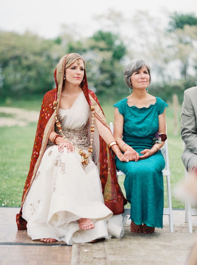 two women sitting next to each other at a wedding