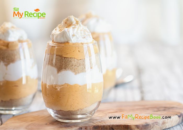 three desserts with whipped cream and pumpkin pie in glass cups on a cutting board