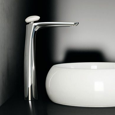 a white sink sitting on top of a counter next to a wall mounted faucet