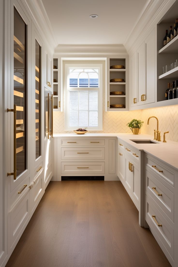 the kitchen is clean and ready for us to use it's white cabinetry