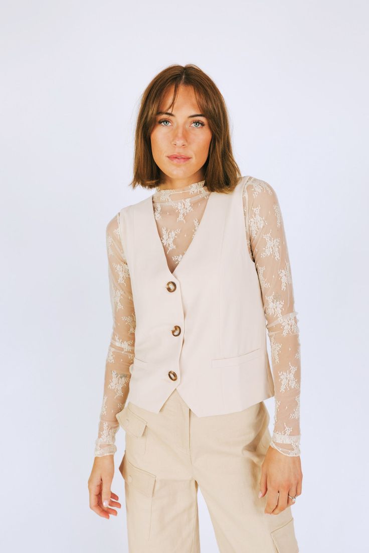 This Above The Rest Vest is the cream of the crop! Not just for fancy occasions, this waistcoat-style vest is perfect for any day of the week. Button up in style with this cream-colored vest. You'll be looking (and feeling) above the rest! Details Sleeveless V-neckline Nonfunctioning pockets Button front closure Lined Sizing Approximate measurements: SIZE LENGTH BUST Small 21” 36” Medium 22” 38” Large 22” 40” Fabric has stretch Model is 5’8” wearing small Material Self: 100% PolyesterLining: 100 Waistcoat Style, Colorful Vest, Style Vest, Day Of The Week, The Cream, Lace Shirt, Winter Sale, Cream Color, In Style