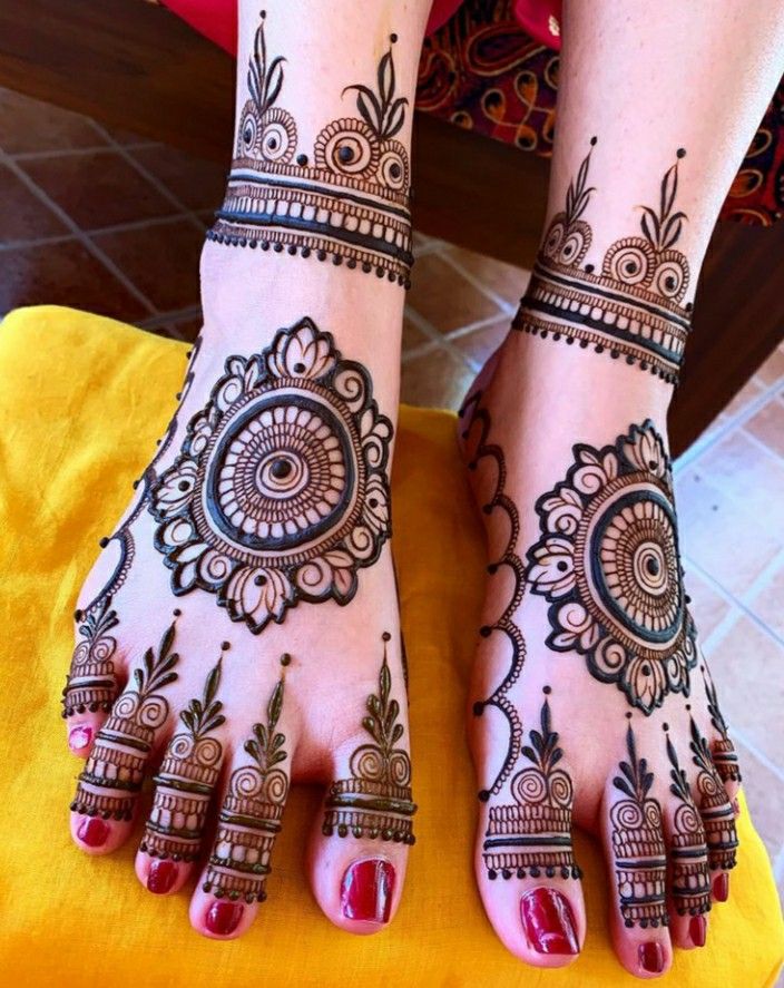 the feet are decorated with henna designs