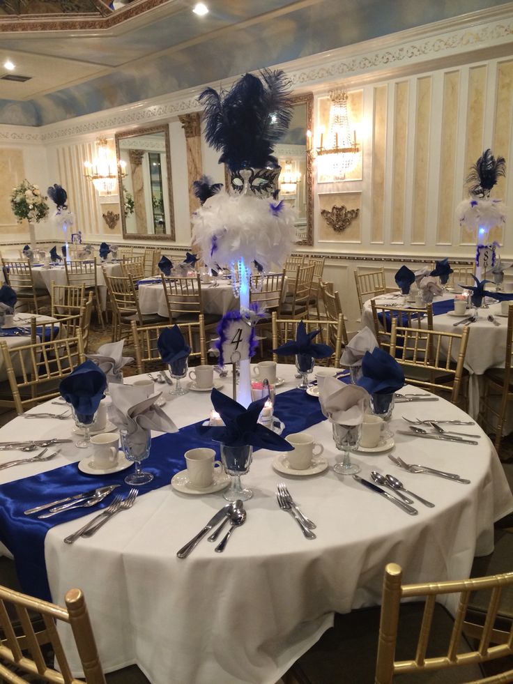 a table set up with blue and white decorations