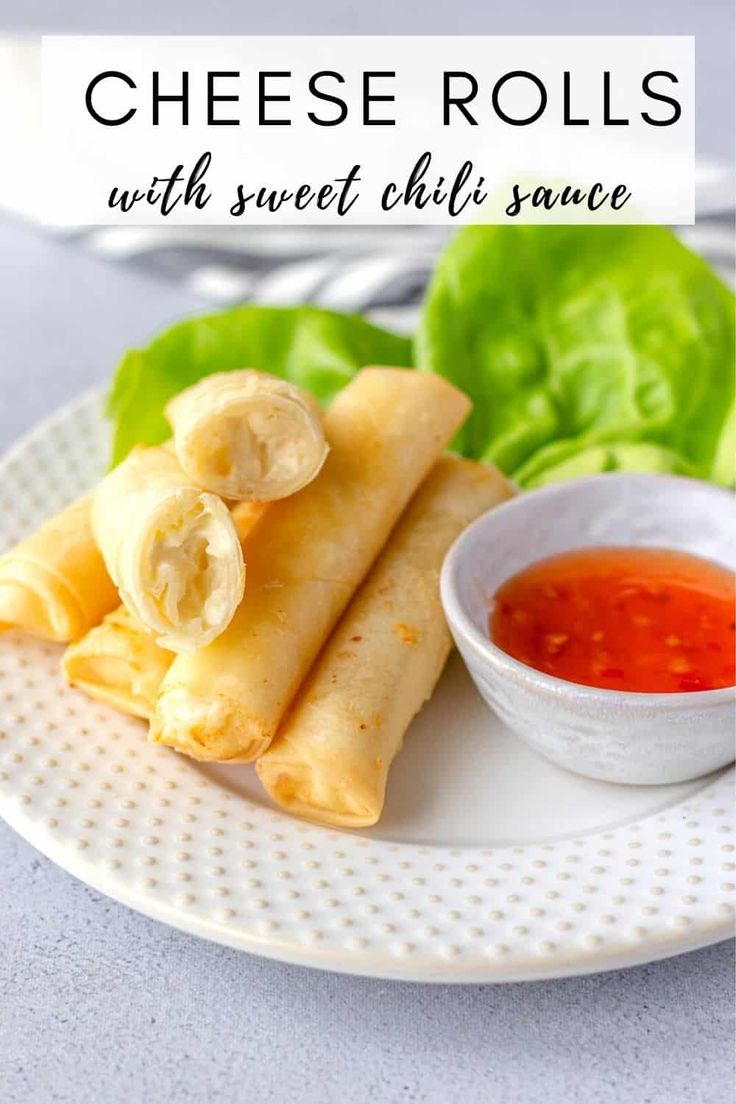 cheese rolls with sweet chili sauce on a plate next to lettuce and dipping sauce