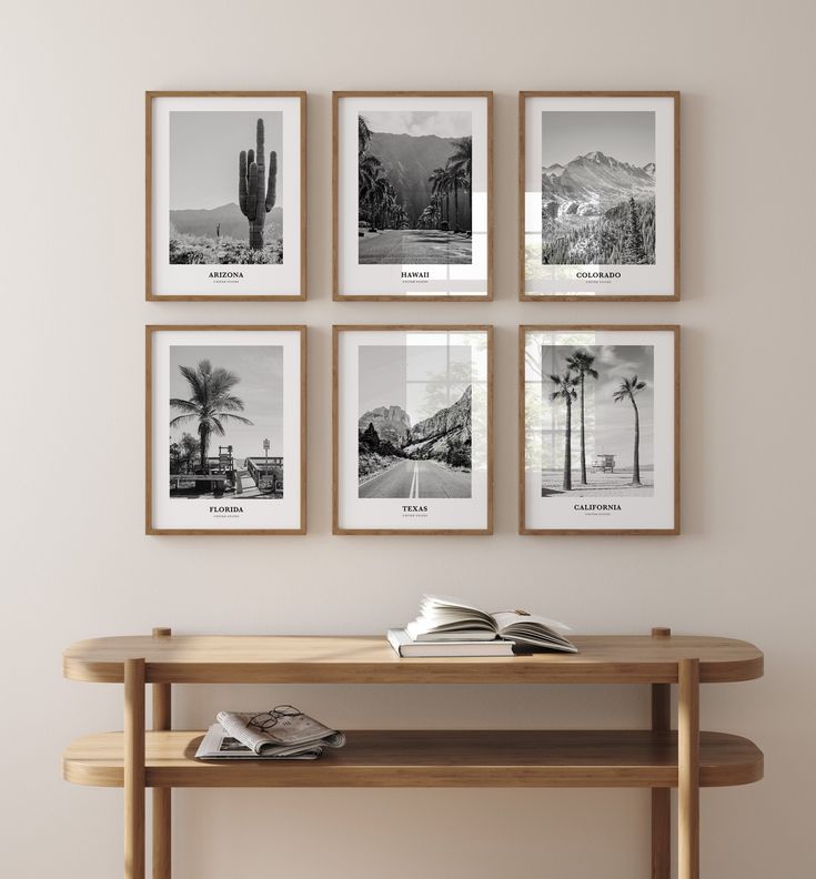 a wooden table with four pictures hanging on the wall